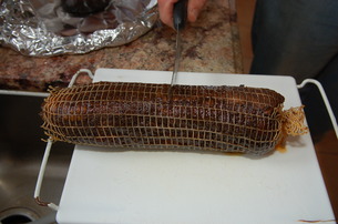 Capicola ready for cutting after 1 year of aging in a glass cylinder filled with vegetable oil